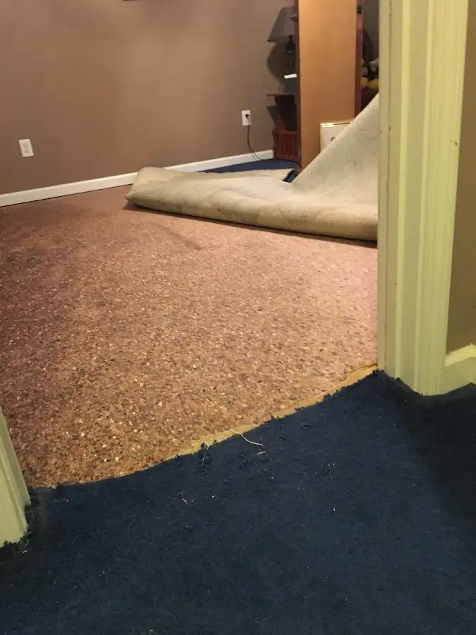 Carpet pad removal revealing water damage during Water Mitigation Services in Conway